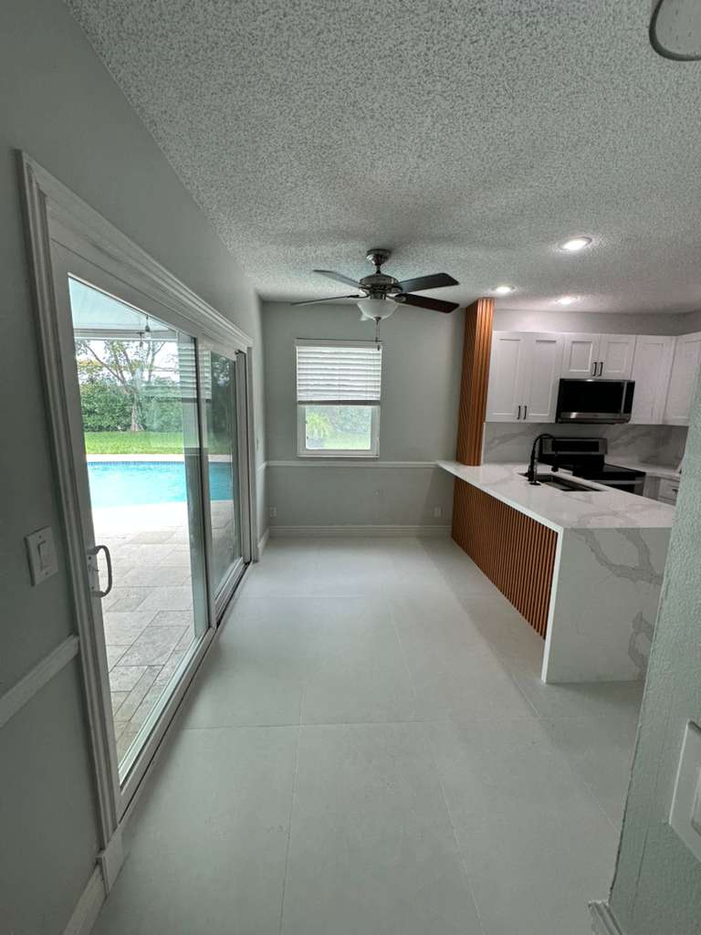 kitchen remodel with white cabinets quartz countertops and pool view – Fort Lauderdale FL