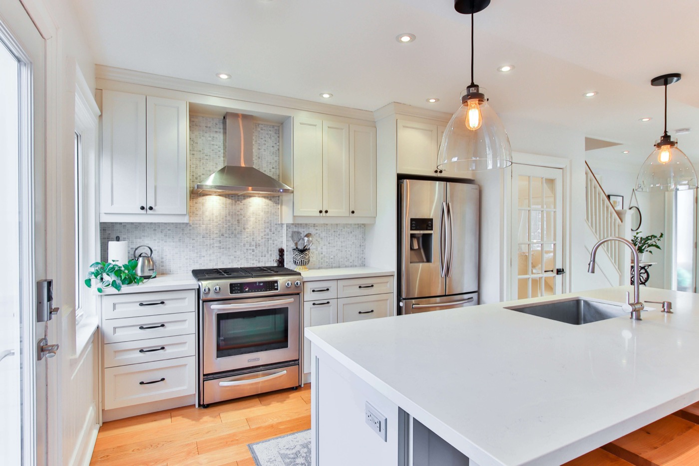 white Shaker kitchen remodel with quartz countertops and stainless appliances – kitchen remodeling North Lauderdale FL